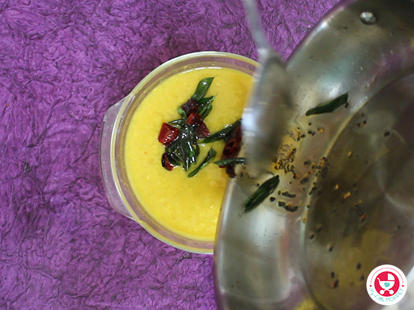 Pour the tempering in cooked mango dal.