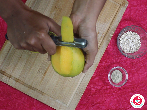 Wash, peel and cut the mango into slices.