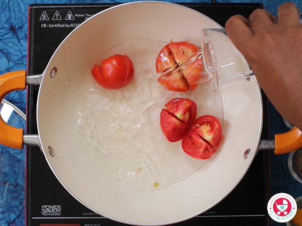 In a pan, add the tomato pieces and water. Cook for 5-10 minutes.